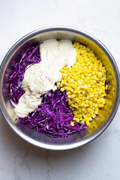 red cabbage coleslaw ingredients in a bowl.
