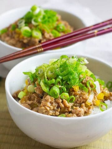 miso ginger pork bowl with scallions on top