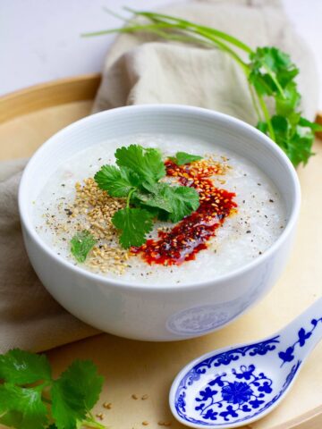 Instant Pot chicken congee with scallion, chili oil, and sesame