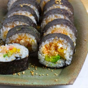Cut side of spicy shrimp sushi rolls.