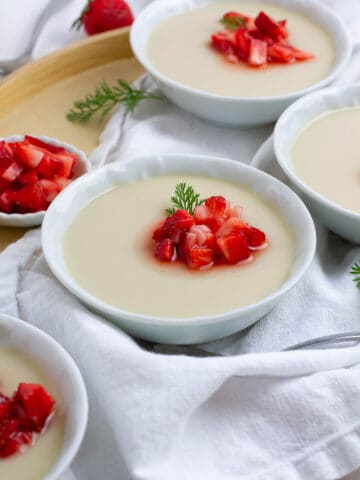 Almond tofu (annin tofu) with strawberry topping in small bowls.