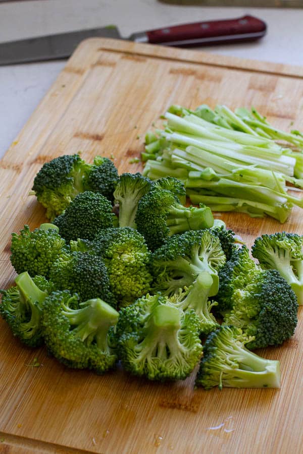 Cut up broccoli florets and thinly cut stem on a cutting board. 