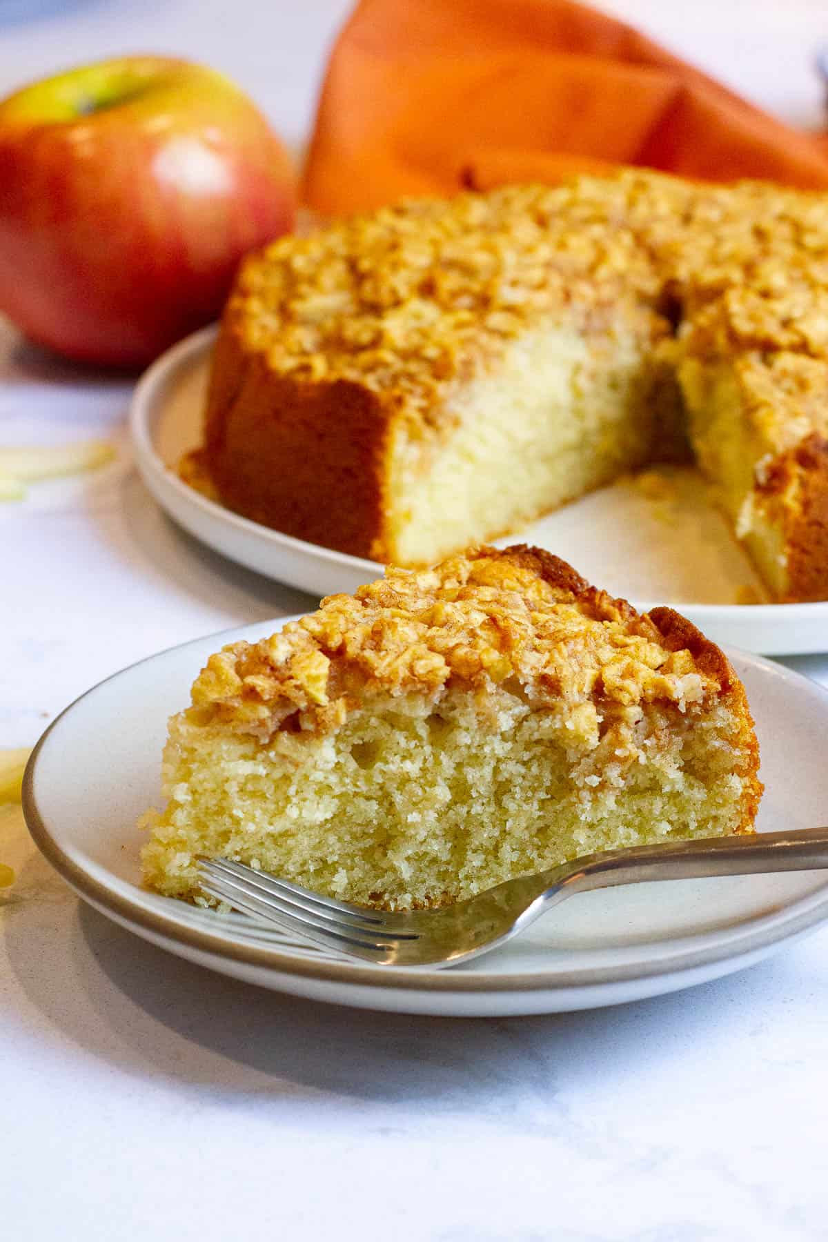 A slice of gluten-free dairy-free apple crumble cake on a plate.