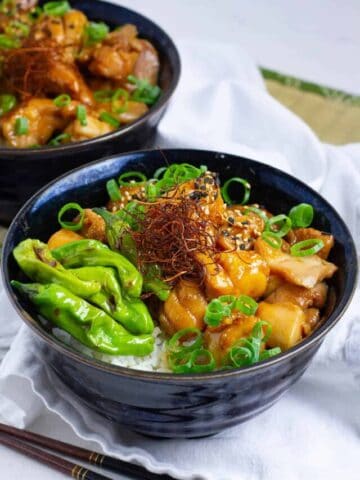 Front view of teriyaki chicken donburi (rice bowl) with shishito peppers.
