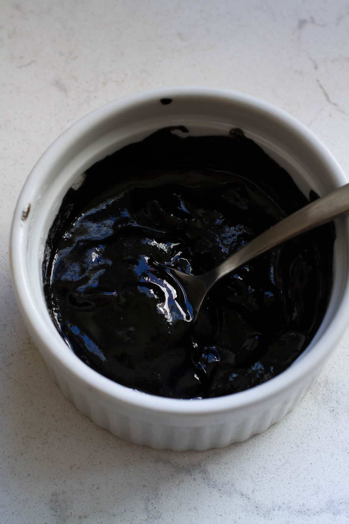 Black sesame paste in a white cup.