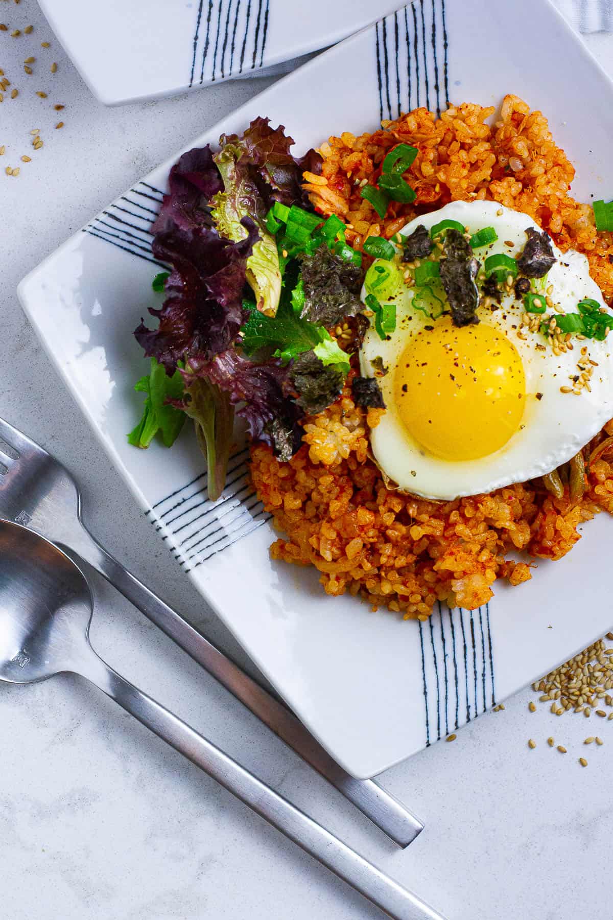 Top view of tuna kimchi fried rice with a sunny side egg topping.