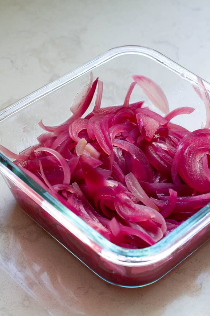 Red onions that have been pickled for one hour.