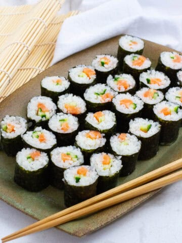 Salmon cucumber hosomaki on a plate.