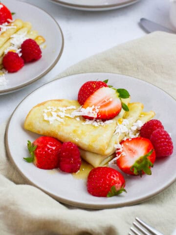 Coconut milk crepes with strawberry topping.