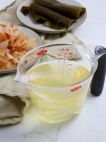 Awase dashi (Japanese soup both) in a measuring cup.