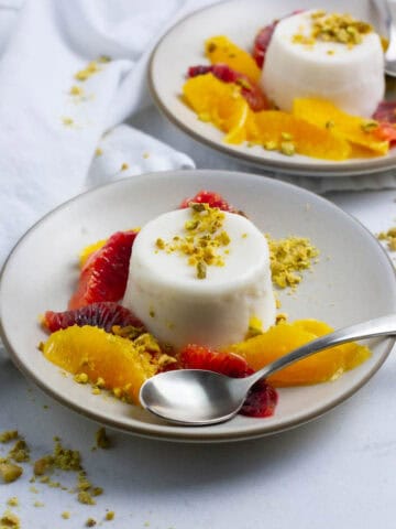 Coconut milk panna cotta with orange slices.