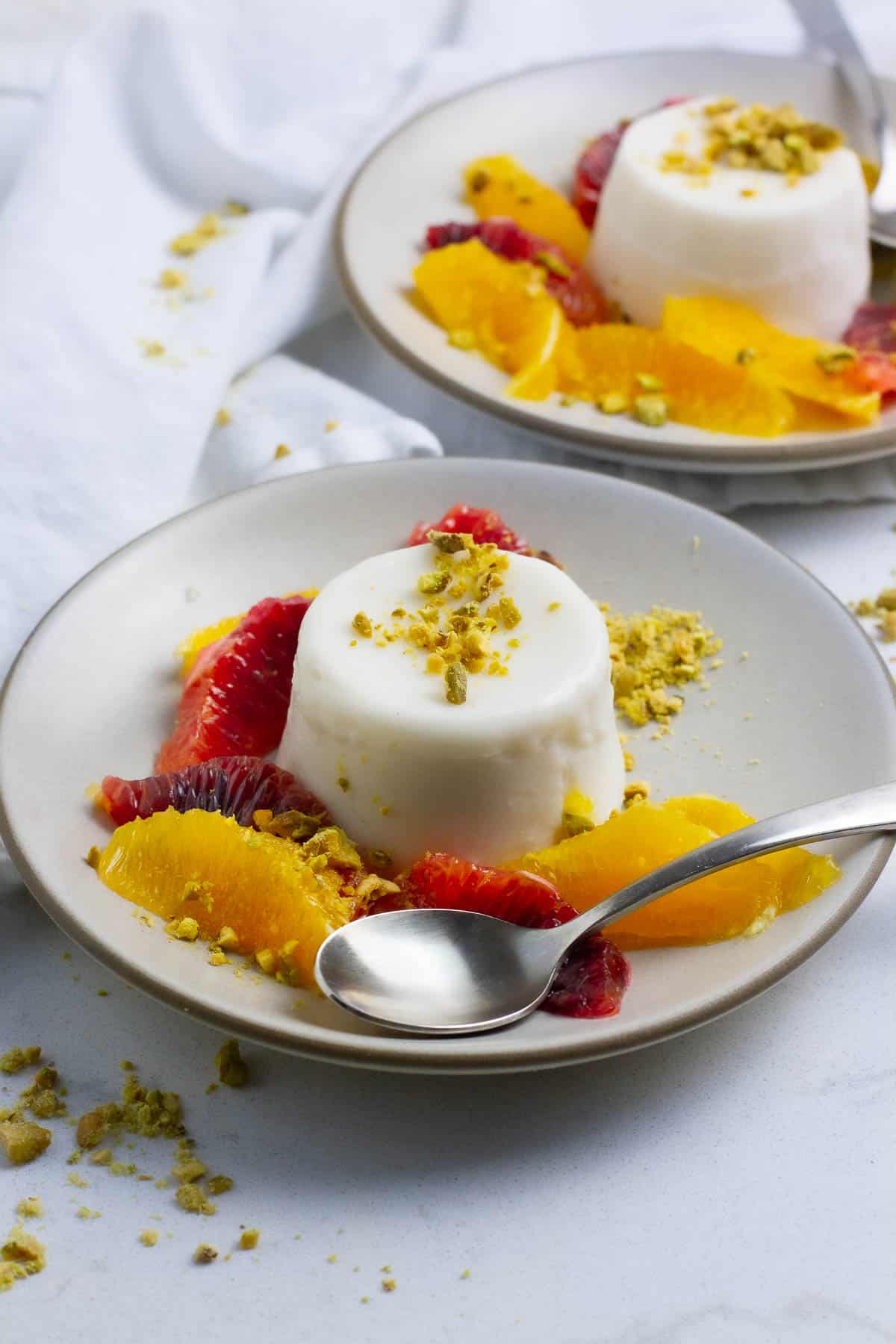 Coconut milk panna cotta with orange slices.
