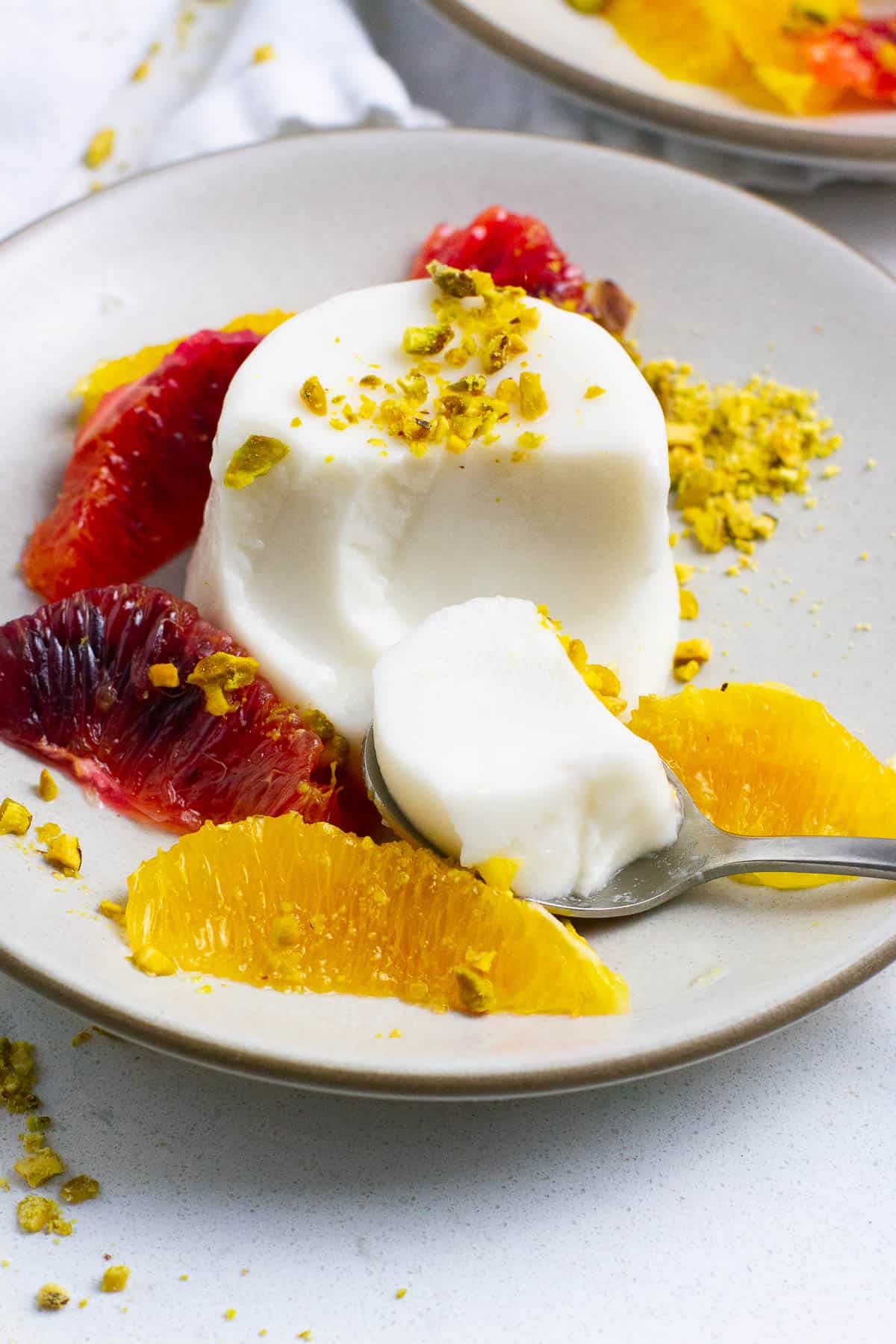 Coconut milk panna cotta being spooned.