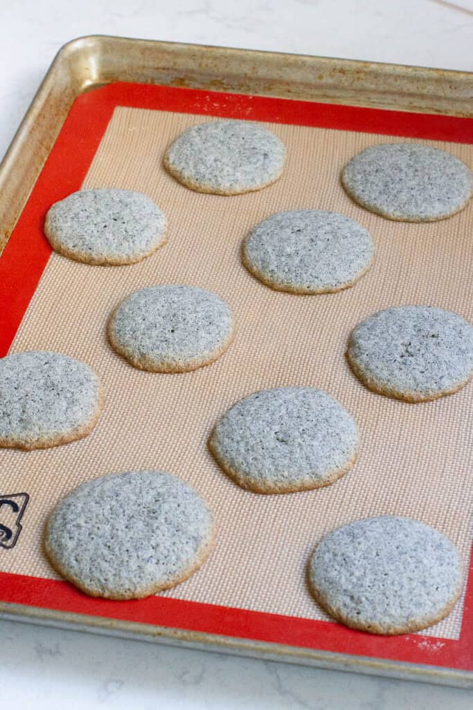 Black sesame cookies on a baking sheet.
