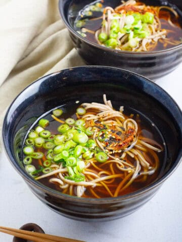 Two bowls of kake soba noodles.