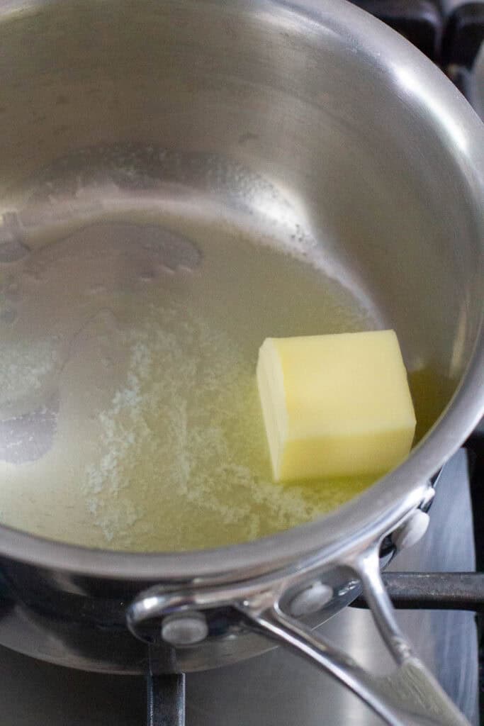 Butter being melted in a saucepan.