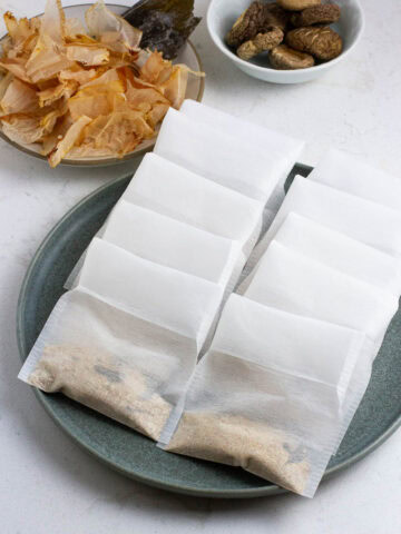 Homemade dashi packets on a plate.