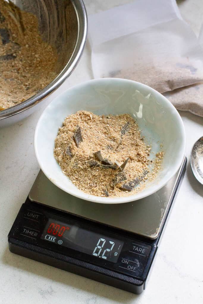 Homemade dashi powder being weighed on a scale.