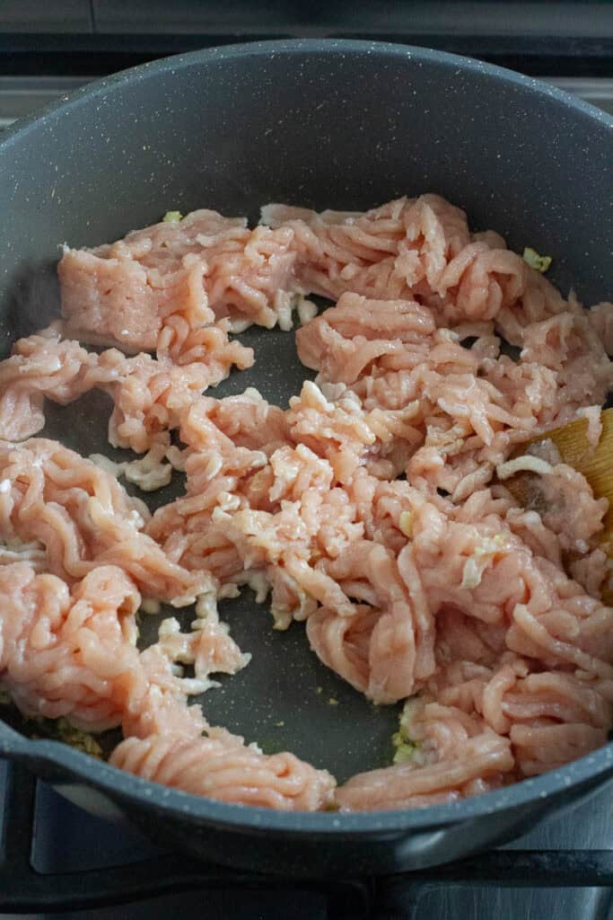 Ground chicken in a pan.