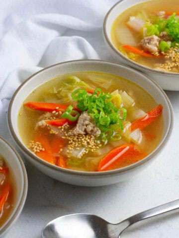 Pork napa cabbage soup in soup bowls.