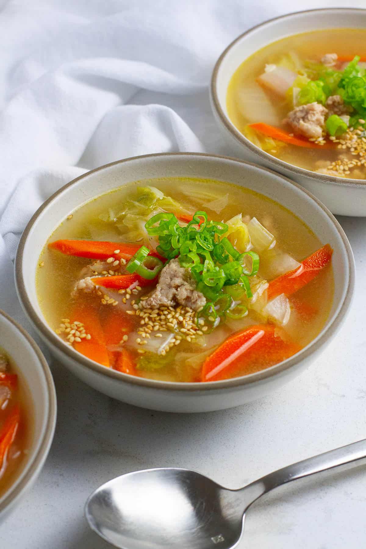 Pork napa cabbage soup in soup bowls.