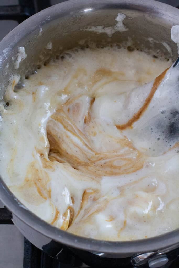Melted marshmallows and peanut butter in a saucepan.