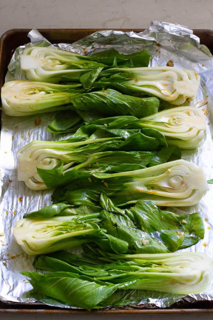 Halved bok choy with sauce drizzled over.