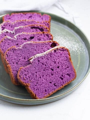 Ube loaf cake slices on a plate.
