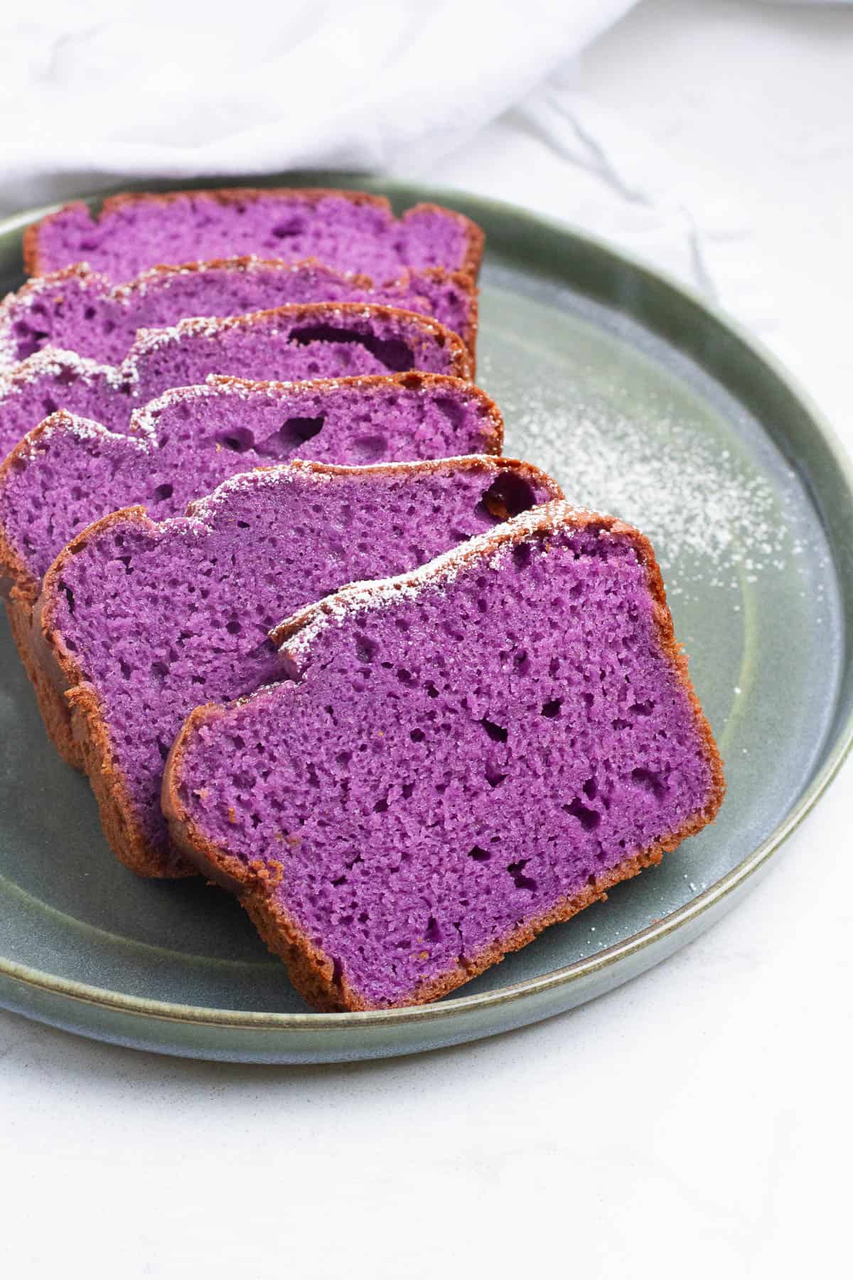 Ube loaf cake slices on a plate.