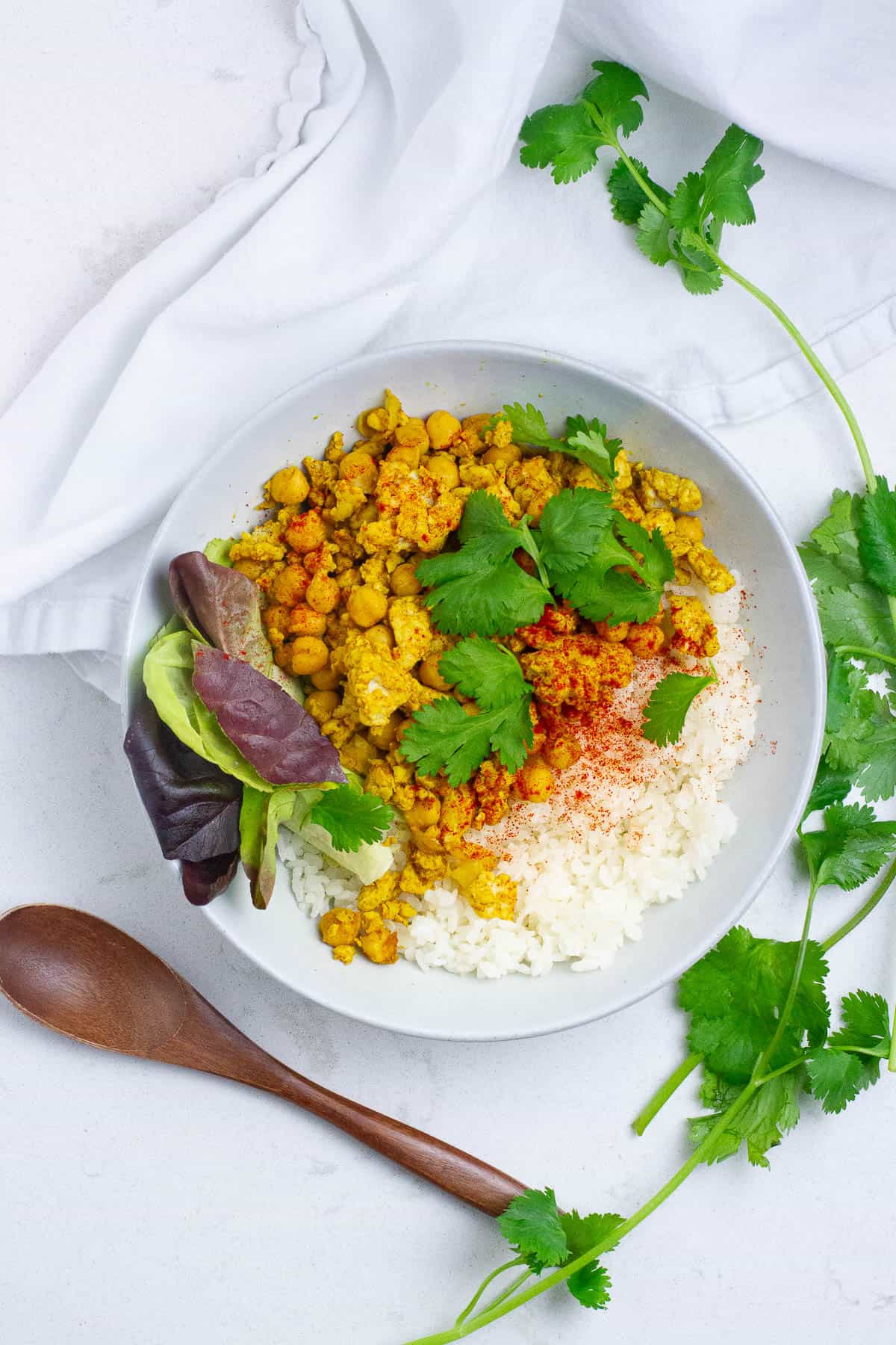 chicken chickpea curried stir fry in a bowl with rice.