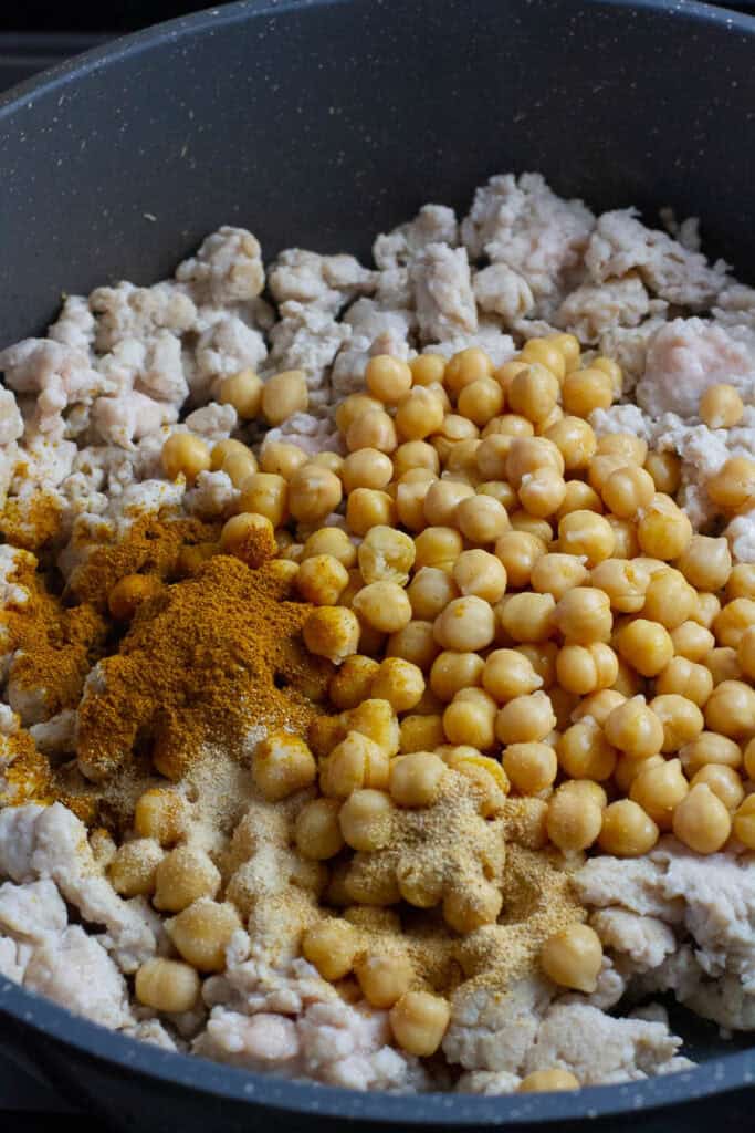 Ground chicken and chickpea cooked in a skillet with spices.