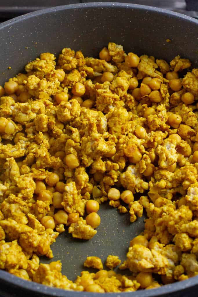 Cooked chicken chickpea curried stir fry in a pan.