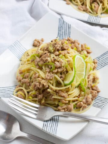 Ground pork pasta on a square plate.