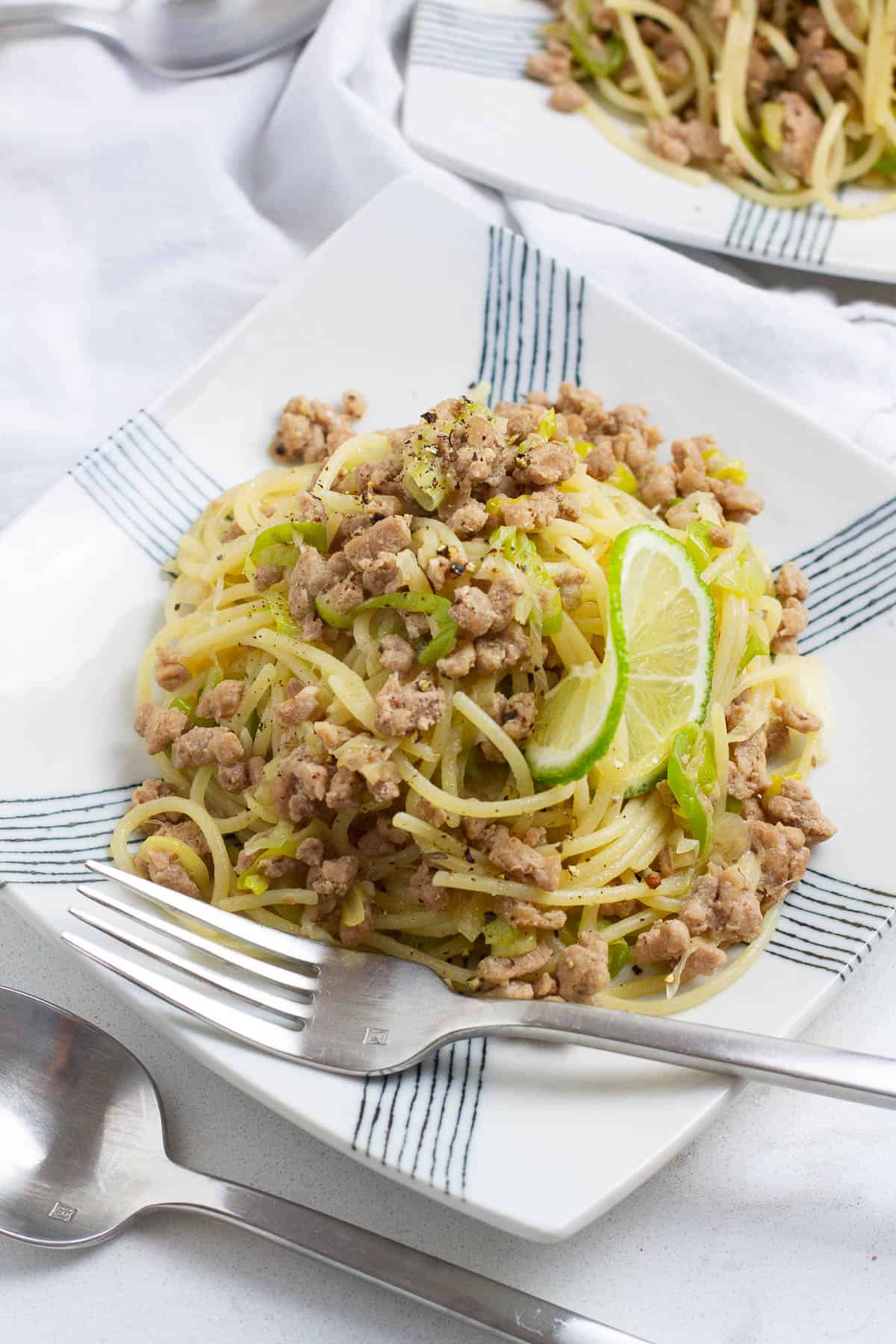 Ground pork pasta on a square plate.