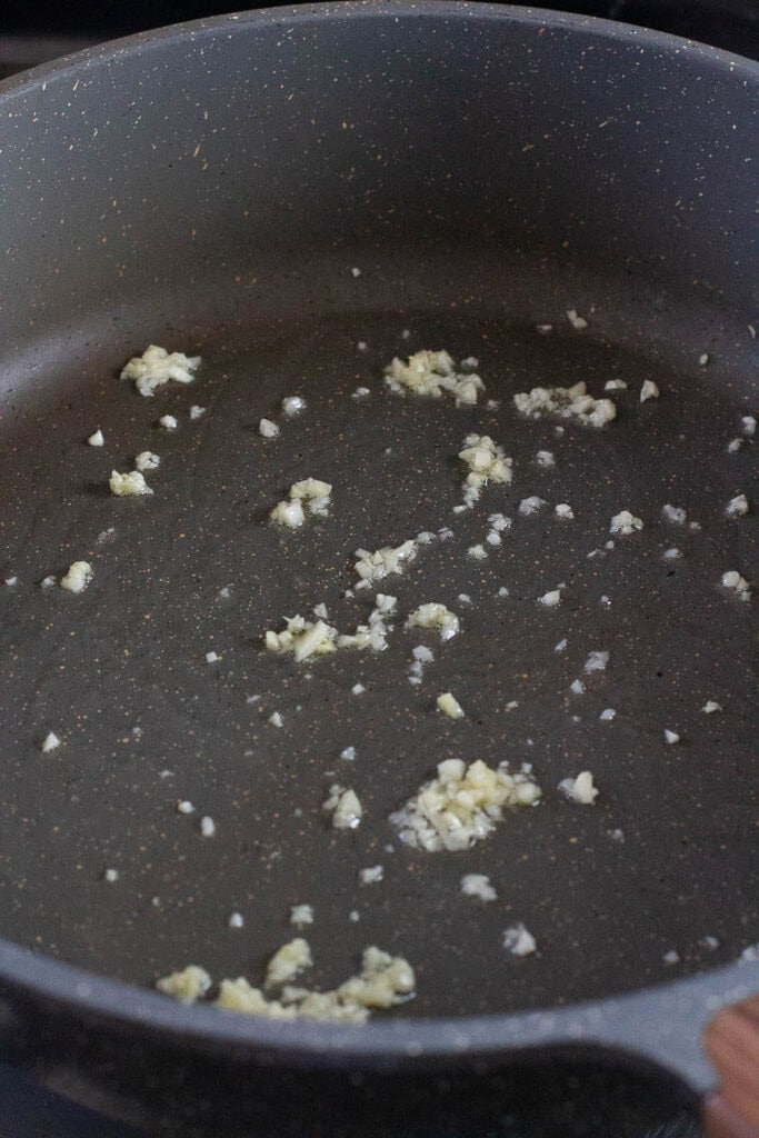 Olive oil and garlic in a pan.