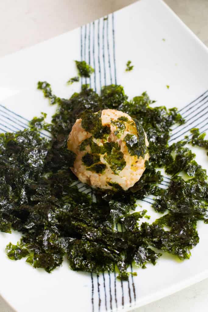 A rice ball covered in seasoned seaweed.