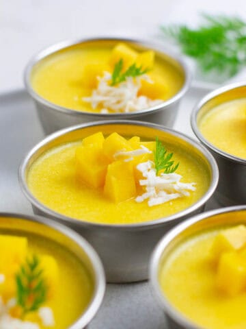 Mango pudding in metal cups.