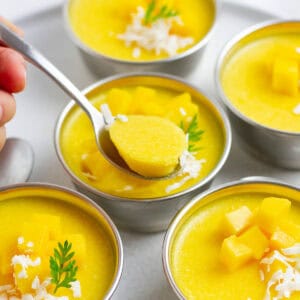 Mango pudding in metal cups.