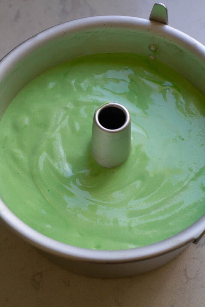 Pandan cake batter in a tube pan.