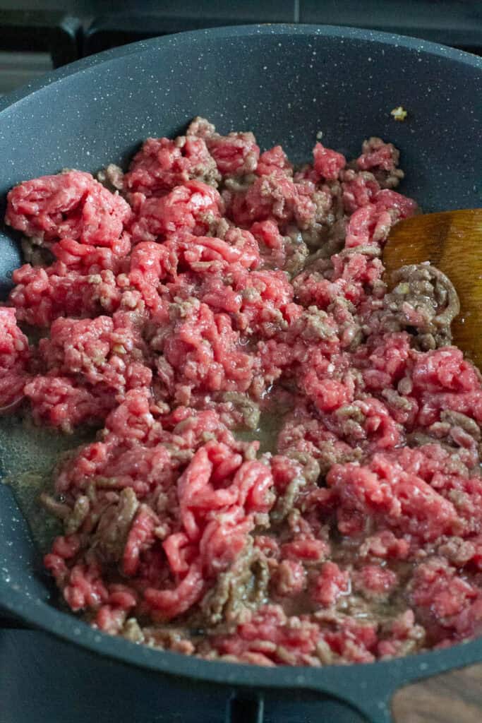 Semi cooked minced beef in a pan.