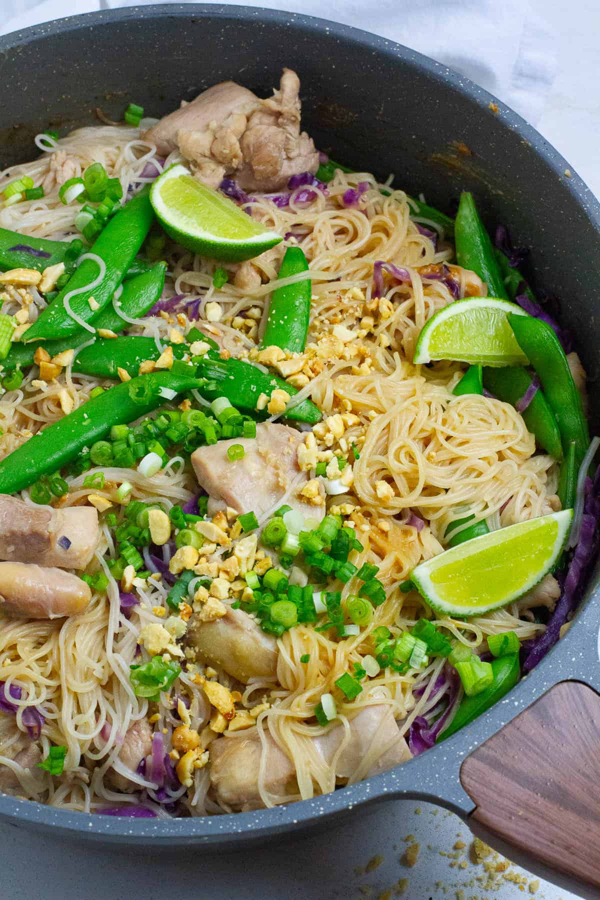 Satay chicken noodles in a frying pan.