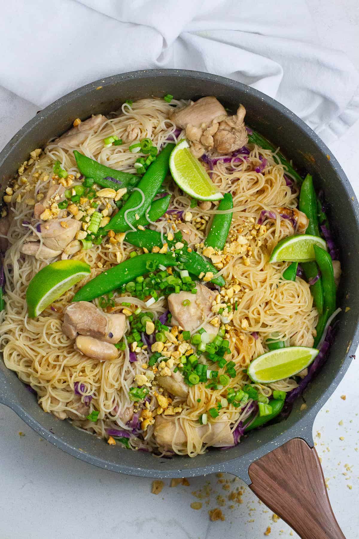 Top view of stay chicken noodles in a pan.