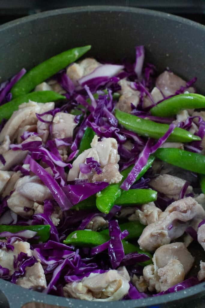Chicken and vegetables cooked in a pan.