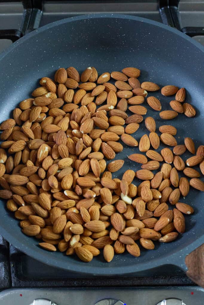 Tamari almonds in a frying pan.