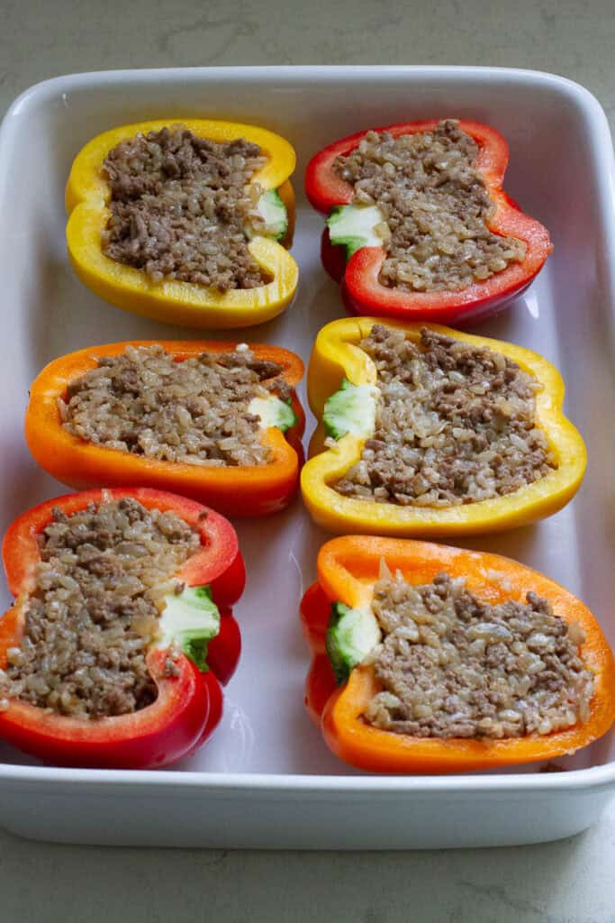 Halved bell peppers with rice and beef stuffing.